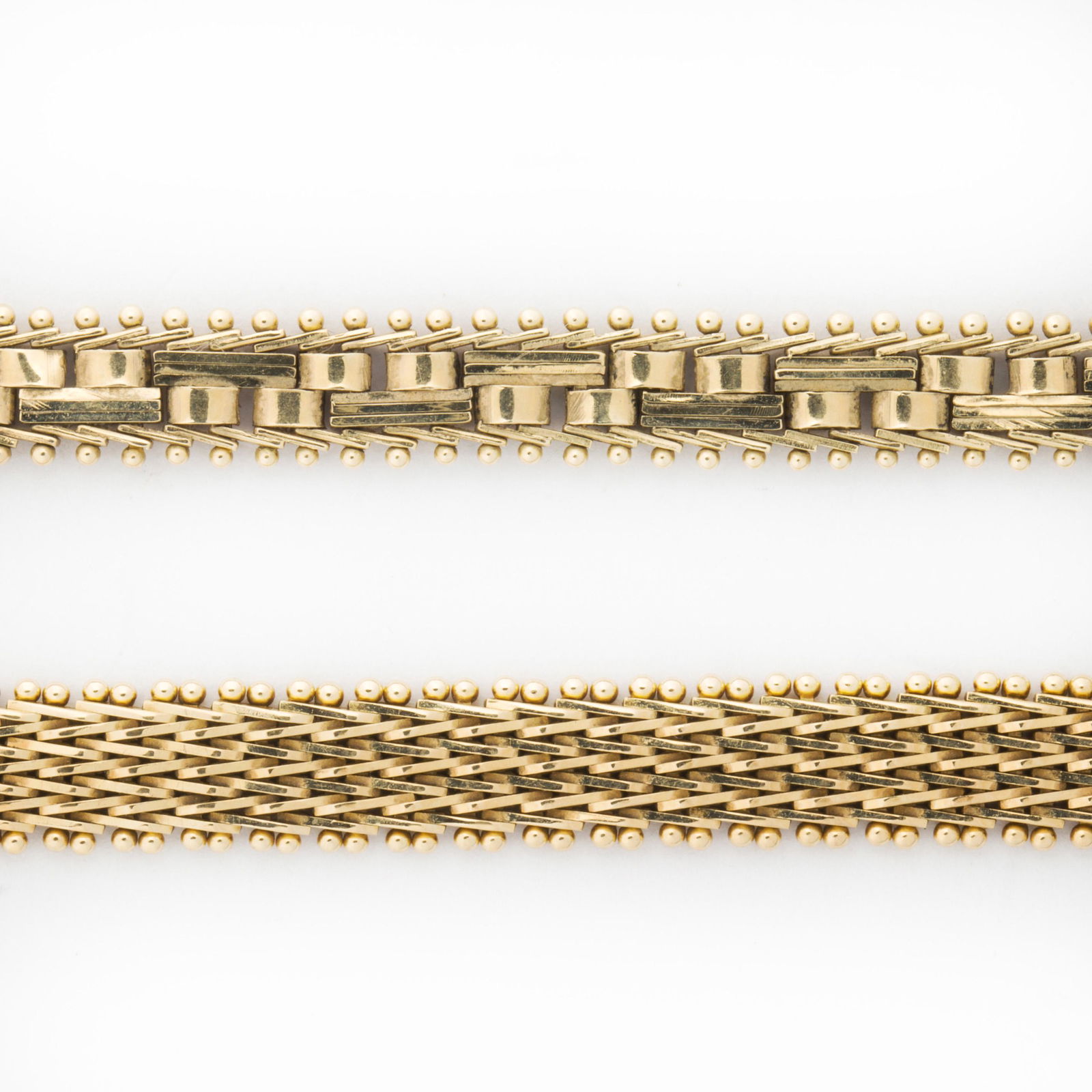 A group of fourteen karat gold bracelets: A group of fourteen karat gold braceletsdesigned as two flexible modified gold link bracelets. 16.9 dwt; lengths: all 8 in
