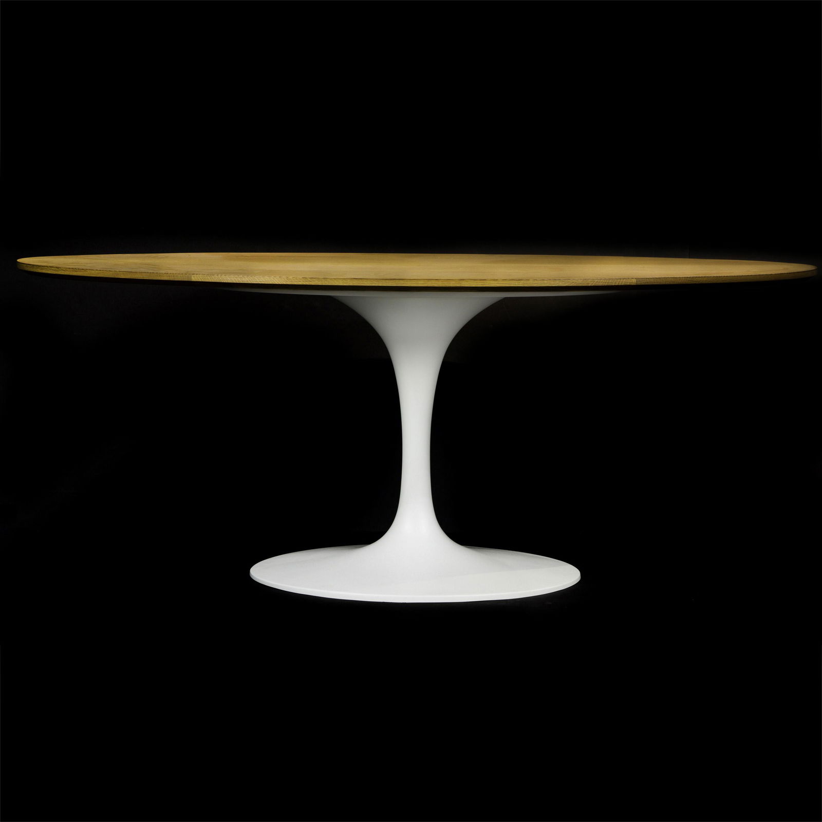 A Saarinen style tulip table having an oval top above a (1 of 3)