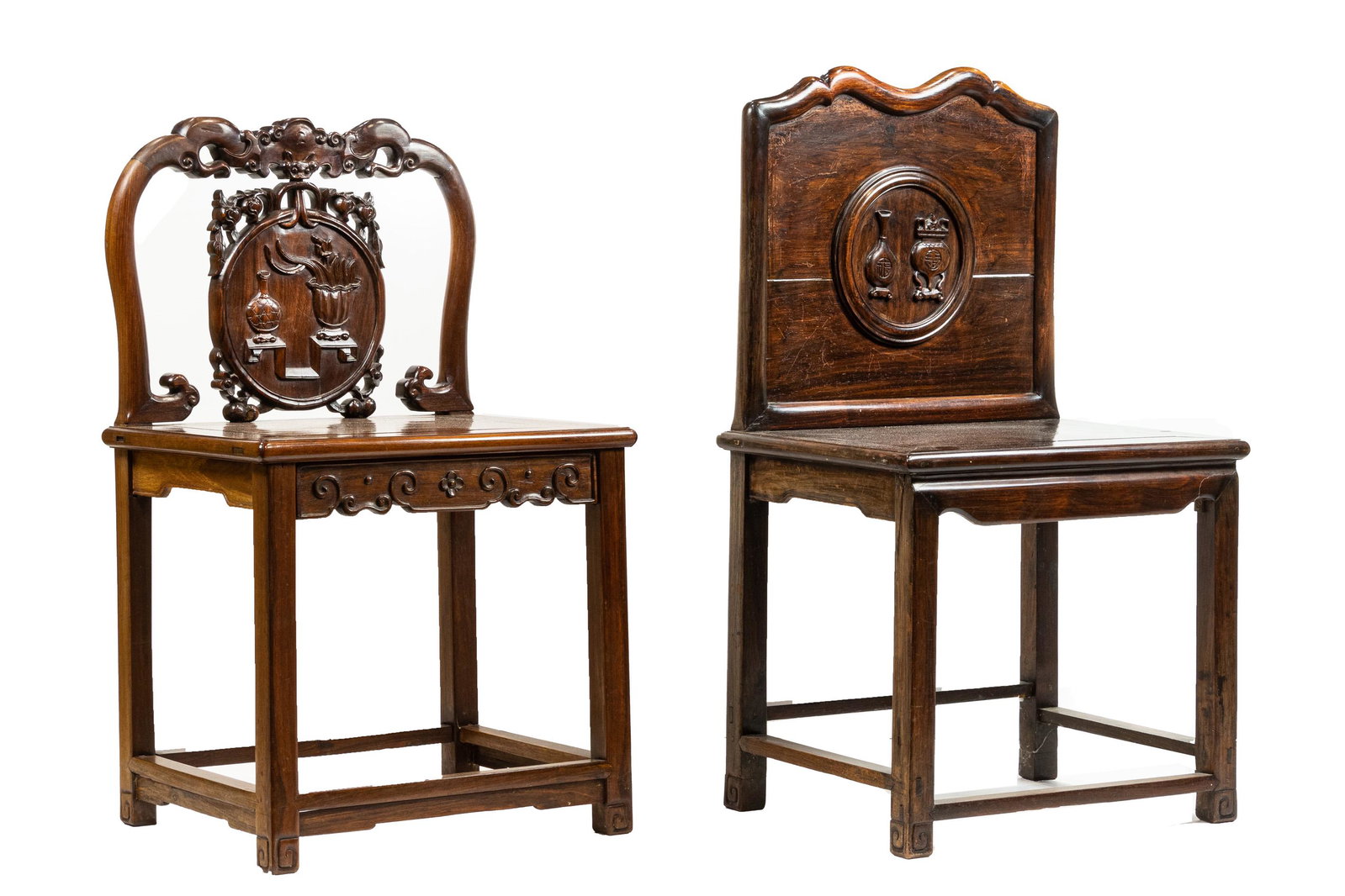 (lot of 2) Chinese hardwood side chairs: (lot of 2) Chinese hardwood side chairs, the first features a medallion carved with antiques; the second features a bat suspending a medallion also displaying various antiques, 38.25"h x 21.25"w x 17"