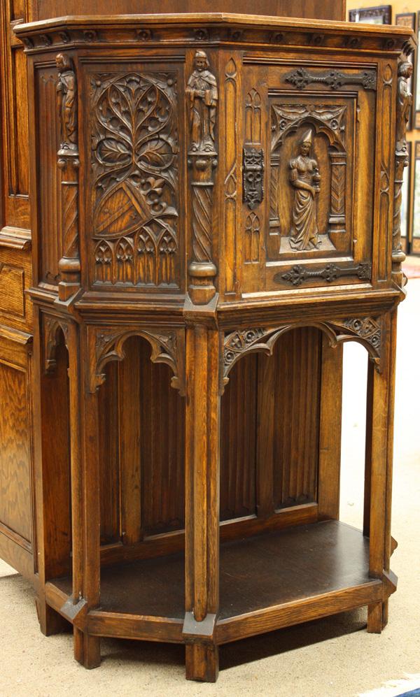 Gothic Style Belgian Cupboard: Belgian Gothic style oak cupboard circa 1920, having a molded crest with carved rosettes above the single door having strap hinges, flanked by high relief carved panels, rising on a conforming base 57