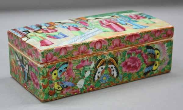 Chinese Export Famille Rose Porcelain Box: Chinese famille rose export porcelain box, the sides of the rectangular container vibrantly enameled with butterflies among rosettes, lotus pod, and pomegranate, the interior separated into two narrow