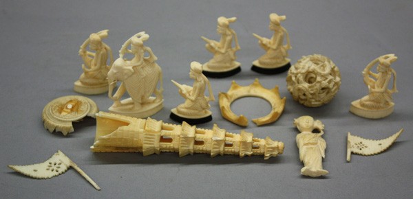 Asian Ivory Carvings: (lot of 13) Asian miscellaneous ivory carvings, consisting of: six small Indian carvings of warriors; two pieced flags; a Chinese tower; one puzzle ball and three miscellaneous pieces from associated 