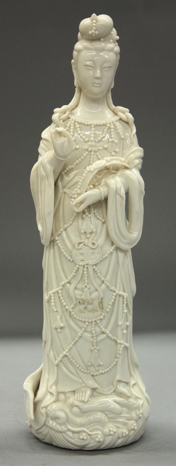 Chinese Blanc de Chine/Dehua Guanyin Figure: Chinese blanc de chine/white ware figure of a bodhisattva, 20th century, probably Guanyin staning in royal attire with 'wish-granting' scepter in the left hand (fingers chipped), 13.25''h