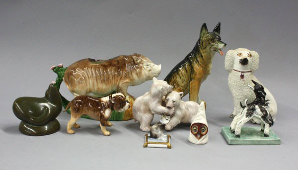 Continental porcelain figurines: (lot of 9) Continental animal porcelain figurines including a German Shepherd, Staffordshire spaniel, Royal Worcester owl candle snuffer, Royal Doulton Brindle bulldog, Danish polar bears, French cat,