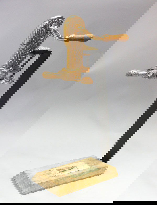 Wine opener on stand: Wine bottle opener on stand, executed in mixed metal, vintner model raised on a wood base, 24''h x 11''l