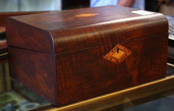 English Lap Desk: English lap desk circa 1870, executed in mahogany and having inlaid medallions flanking the escutcheon and lid, opening to reveal a later felt writing surface and a fitted pen tray and ink reservoirs,