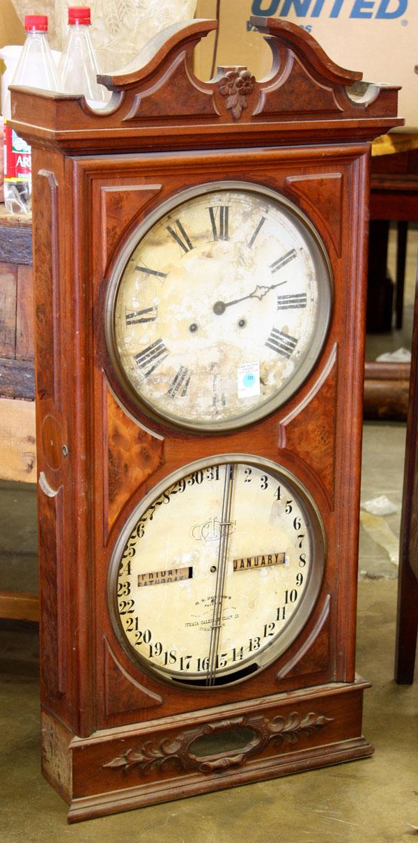 Ithaca Calendar Clock: Ithaca Calendar Clock, wall mount double dial clock in a walnut and raised burl case, lacking lower glass and hand, top lacking minute hand, 40.5''h x 19.5''w x 6''d
