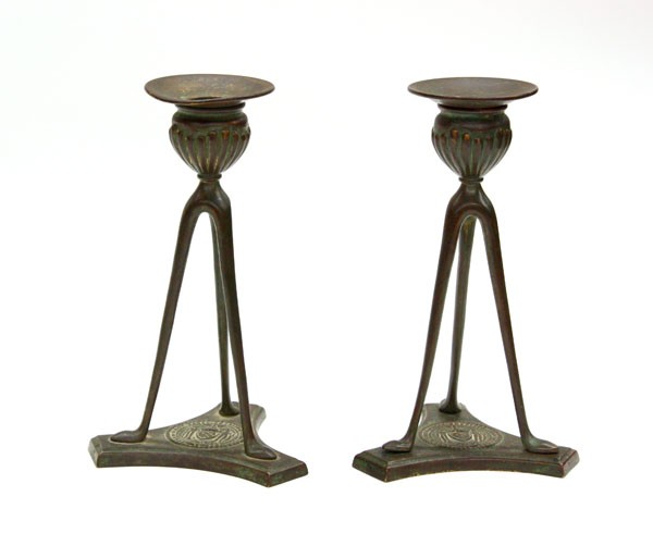 Tiffany Studios candlesticks: Pair of Tiffany Studios candlesticks, each executed in patinated bronze, the three legs conjoined by a triangular base with a presentation plaque '' First Panel Sheriffs Jury 1905-1906'', base signed 