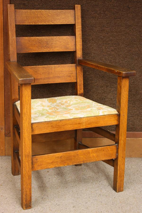 Stickley Brothers Armchair: Stickey Brothers oak armchair circa 1910, having a ladder back and rising on square legs, chair retains original finish with a recovered drop in seat, signed with metal tag 38''h x 25.5''w
