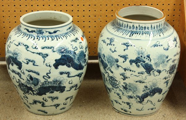 Chinese Blue-and-White Porcelain Jars: (lot of 2) Chinese underglaze blue decorated porcelain jars, each of the tapering ovoid bodies with a scene of seven fu-lions in pursuit of ribboned brocade balls amid cloud scrolls, the high shoulder