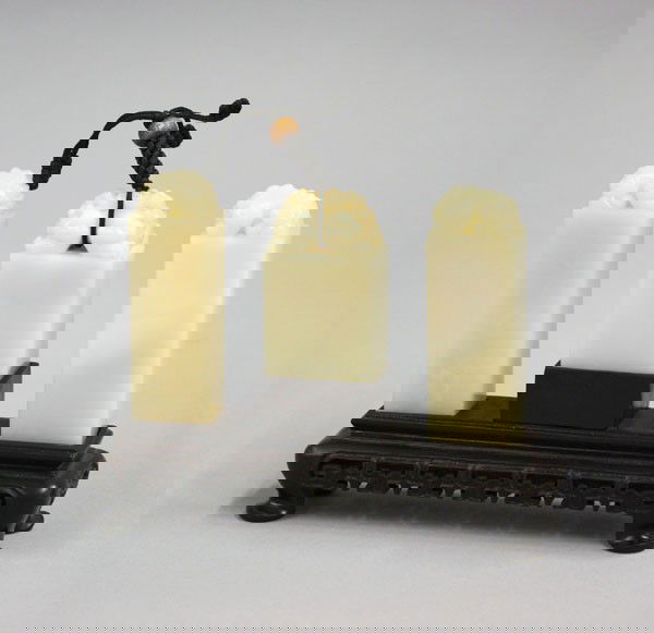 Chinese Fine San Lian Zhang Stone Three Seal Set: Set of three Chinese fine soapstone jade seals (san lian zhang) with carved hardwood stand, consisting of a pair of two tall seals each surmounted by a recumbent qilin, the other surmounted by a two h