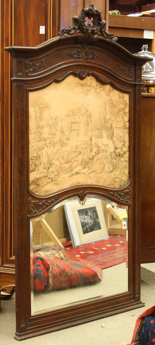 Louis XV style carved oak trumeau mirror: Louis XV style carved oak trumeau mirror circa 1900, the scrolled foliate crest with shell form cartouche surmounting a tapestry panel depicting a classical courting scene, the shaped bevelled mirror