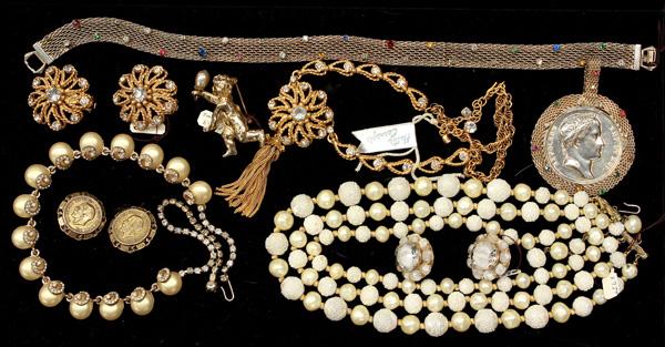 Fashion jewelry including Hattie Carnegie: (lot of 9) Pieces of fashion jewelry including; a Carnegie triple strand faux pearl necklace, a Hattie Carnegie faux pearl necklace with clear rhinestone swirl decoration, a pair of Carnegie clip-on e