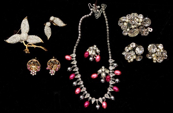 Fashion jewelry including Hattie Carnegie: (lot of 7) Pieces of Hattie Carnegie fashion jewelry including; a gold tone flower brooch and earring set accented by numerous clear rhinestones, round gold tone clip on earrings with clear, pink and 