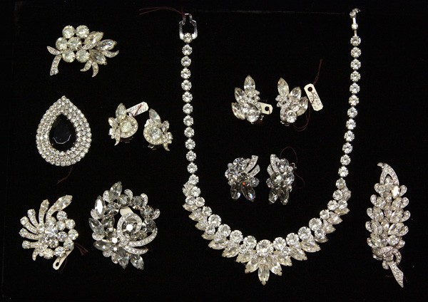 Eisenberg Ice fashion jewelry: (lot of 9) Eisenberg Ice fashion jewelry in clear rhinestones including a necklace, four brooches, one with a central black onyx rhinestone, two pairs of earrings and a brooch and earring set