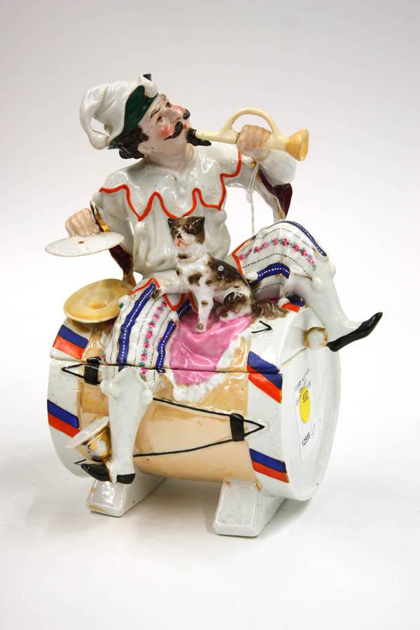 Staffordshire porcelain figural humidor: Staffordshire polychromed porcelain figural humidor of a court jester, 9''h x 6''w x 5.5''d, (slight paint loss on tip of shoe)