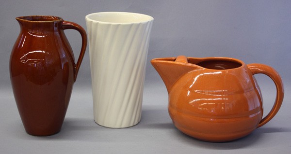 Arts and Crafts pottery, Bauer and McCoy: (Lot of 3) Arts and Crafts pottery, including a Bauer tan ring pitcher, a McCoy brown pitcher, and a white Bauer swirl vase, largest 8.5''h x 5.25''w
