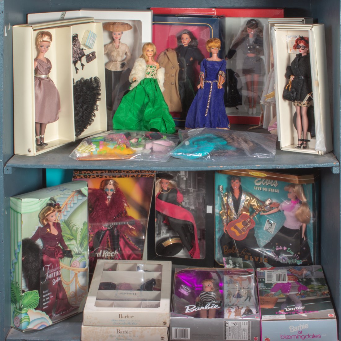 Two shelves of mostly cased Barbie Dolls (1 of 1)