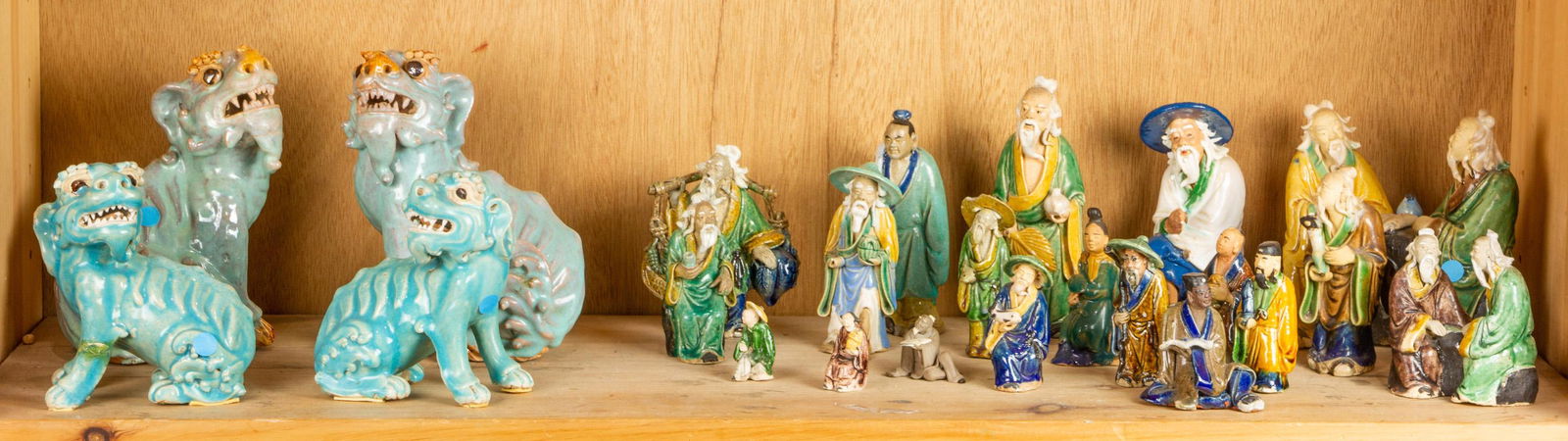 A shelf of Chinese glazed ceramic figurines (1 of 1)
