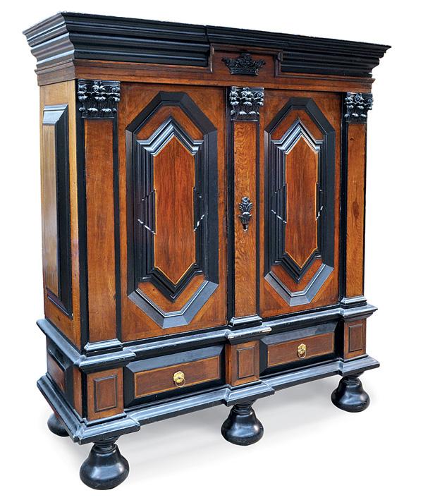 Continental Baroque style armoire: Continental Baroque style armoire circa 1850, the broad cornice and relief carved crown form medallion above the corinthian pilasters flanking the paneled doors, entire case having a partial ebonised