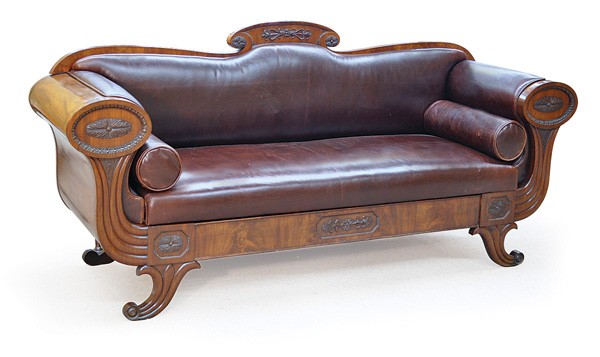 Biedermeier mahogany sofa: Biedermeier sofa circa 1825, executed in mahogany and having an applied foliate medallion flanked with the oval carved rosettes, the arms with conforming carving above the reeded returns terminating a