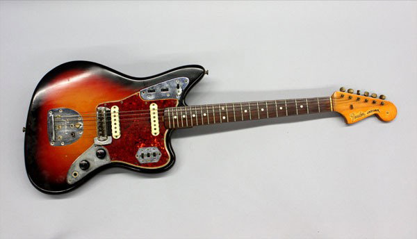 Fender Jaguar electric guitar: 1965 Fender Jaguar electric guitar, all original, sunburst body, tortoise shell pickguard with metal accents, mute rocker, serial number L70053, with hard case and original manual
