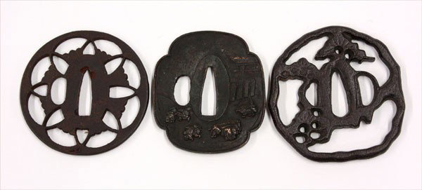Japanese Iron Tsuba (Sword Guards): (lot of 3) Japanese iron tsuba (sword fittings), the first two Edo period, including a circular sukashi guard pierced with ginko leaves, and a mokko-shaped guard with relief design of travelers near a