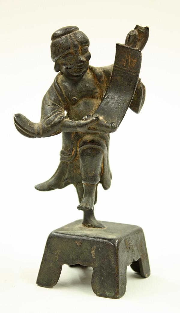 Chinese Bronze Buddhist Figure: Chinese patinated bronze Chan Buddhist figure of Hanshan, Qing dynasty, the dynamic figure in mid-step and cast with an opened scroll in his out-stretched hands, all raised on a tapering pedestal, ove