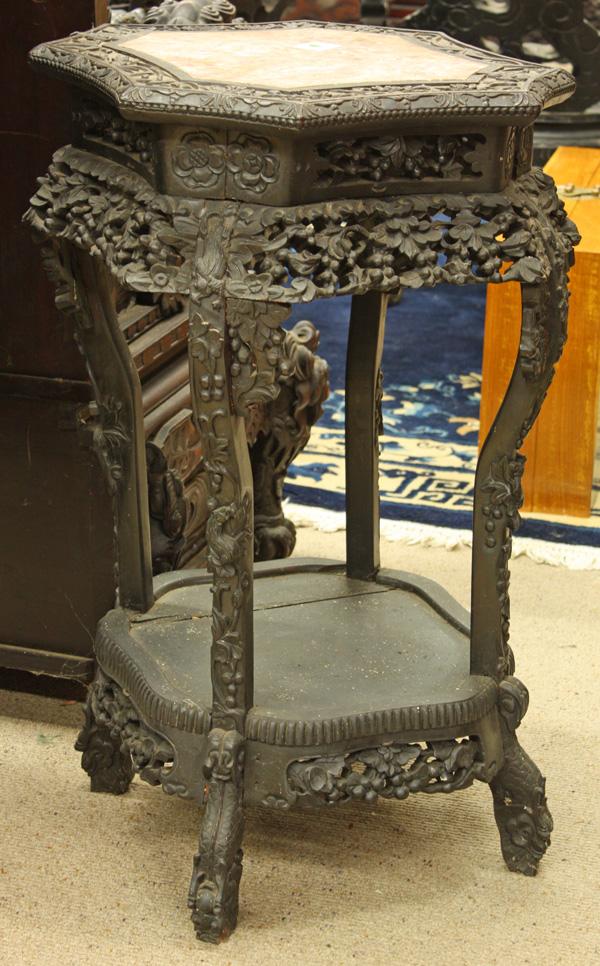 Chinese Export Octagonal Stand: Chinese mable inlaid ebonized wood export octagonal stand, late 19th/early 20th century, the mable plaque of mottled pink color and set within a relief-carved border of flowering sprays and foliate-pa