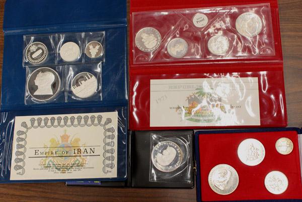 Iran, Jersey, Guinea, Haiti: Lot of foreign coins and proof sets. Sets include 1971 Empire of Iran, 1972 Bailiwick of Jersey, 1973 Republic of Haiti, and a 1970 five hundred francs coin of Guinea. All in albums, some with certifi