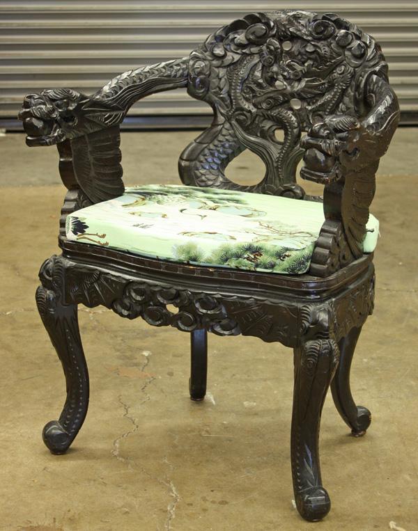 Japanese Ebonized Wood Dragon Chair: Japanese ebonized wood export dragon chair, the back splat carved with a writhing dragon bracketed by a pair of dragon-form arms headed by the majestic mythical beast clutching sacred jewels, the serp
