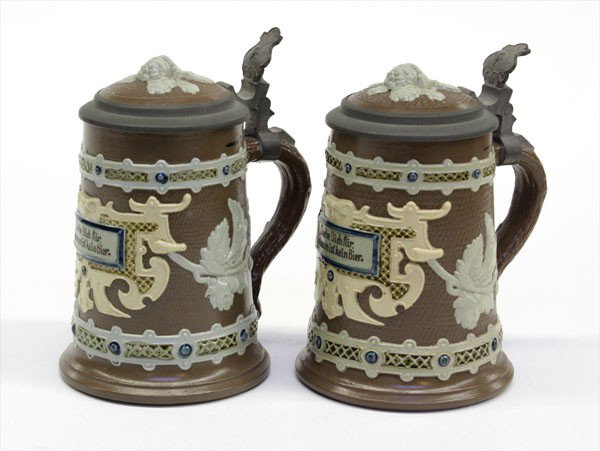 German Mettlach beer steins: Pair of Mettlach lidded tapestry steins, marked and numbered 1745 on base 6''h
