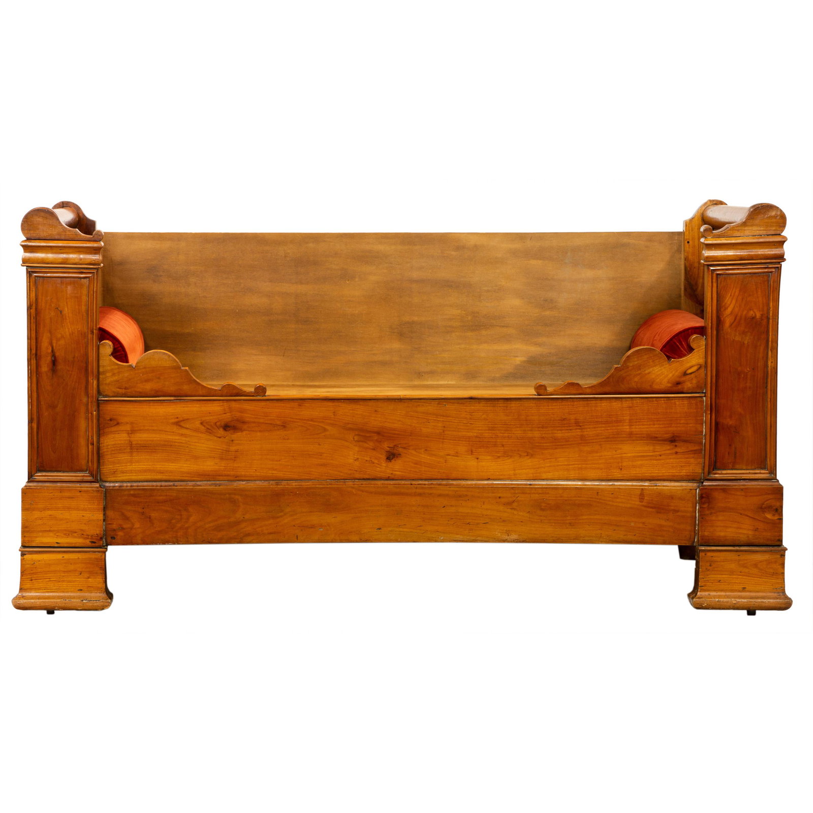 A Louis Philippe fruitwood daybed circa 1860: A Louis Philippe fruitwood daybed circa 1860, having paneled fronts with dowel construction, and rising on out swept feet, with later bolsters, 41"h x 75"w x 28"d