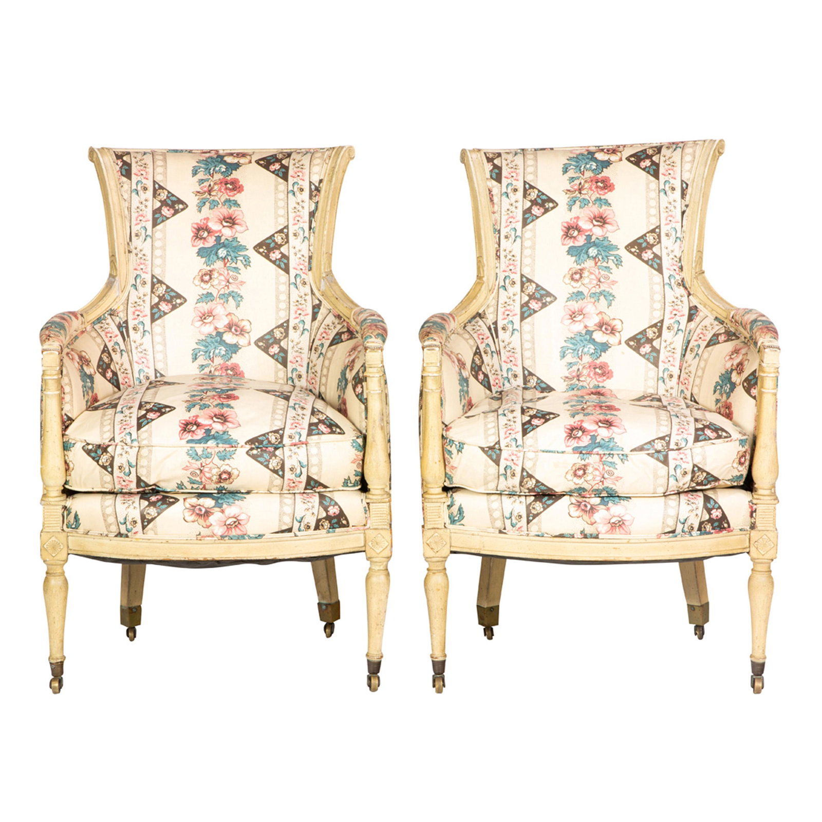 A pair of Louis XVI style bergeres: A pair of Louis XVI style bergeres, each having floral upholstery above baluster form legs terminating on casters, 36"h