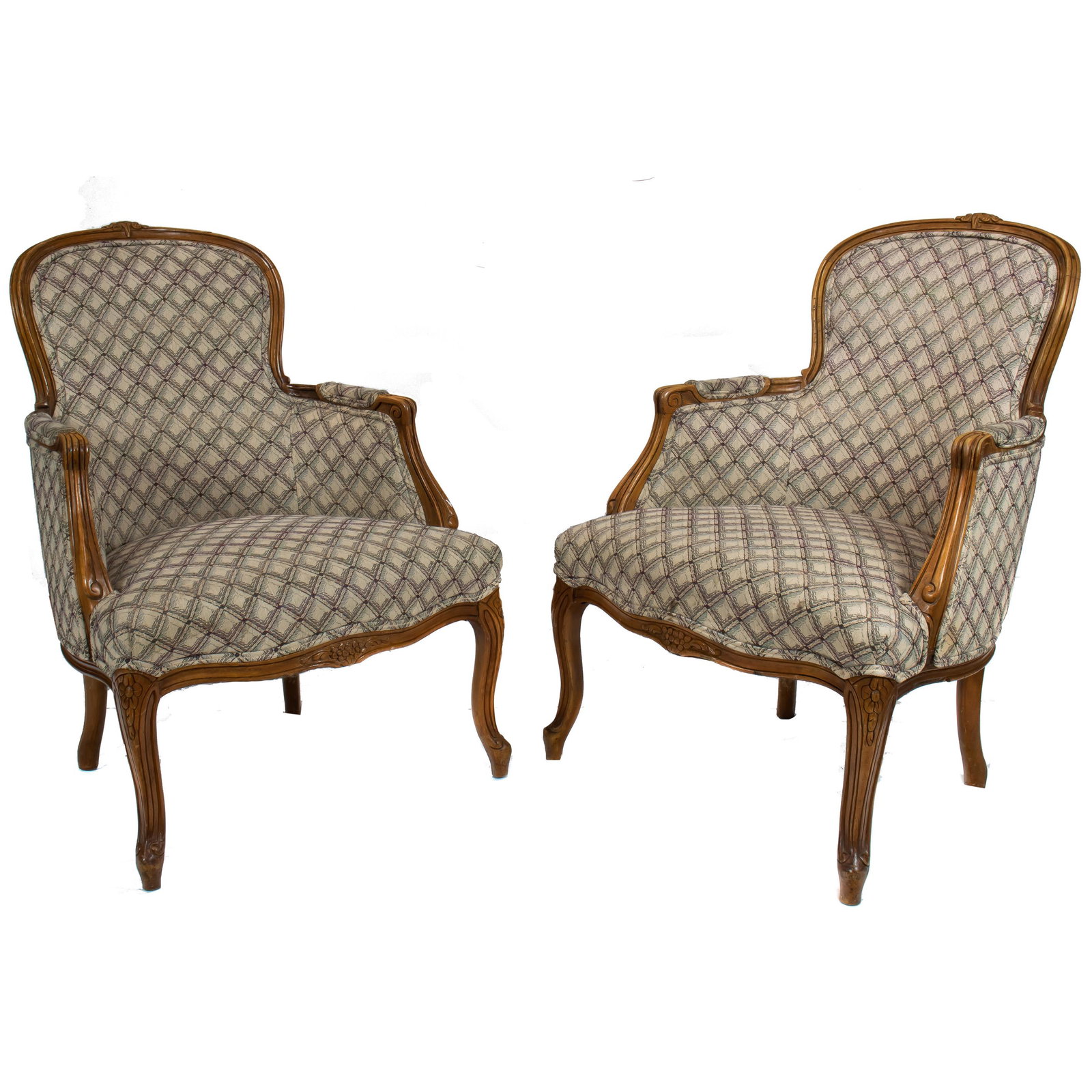 A pair of French Provincial style bergeres: A pair of French Provincial style bergeres, each having geometric decorated upholstery and rising on cabriole legs, 36"h x 26"w x 16"d