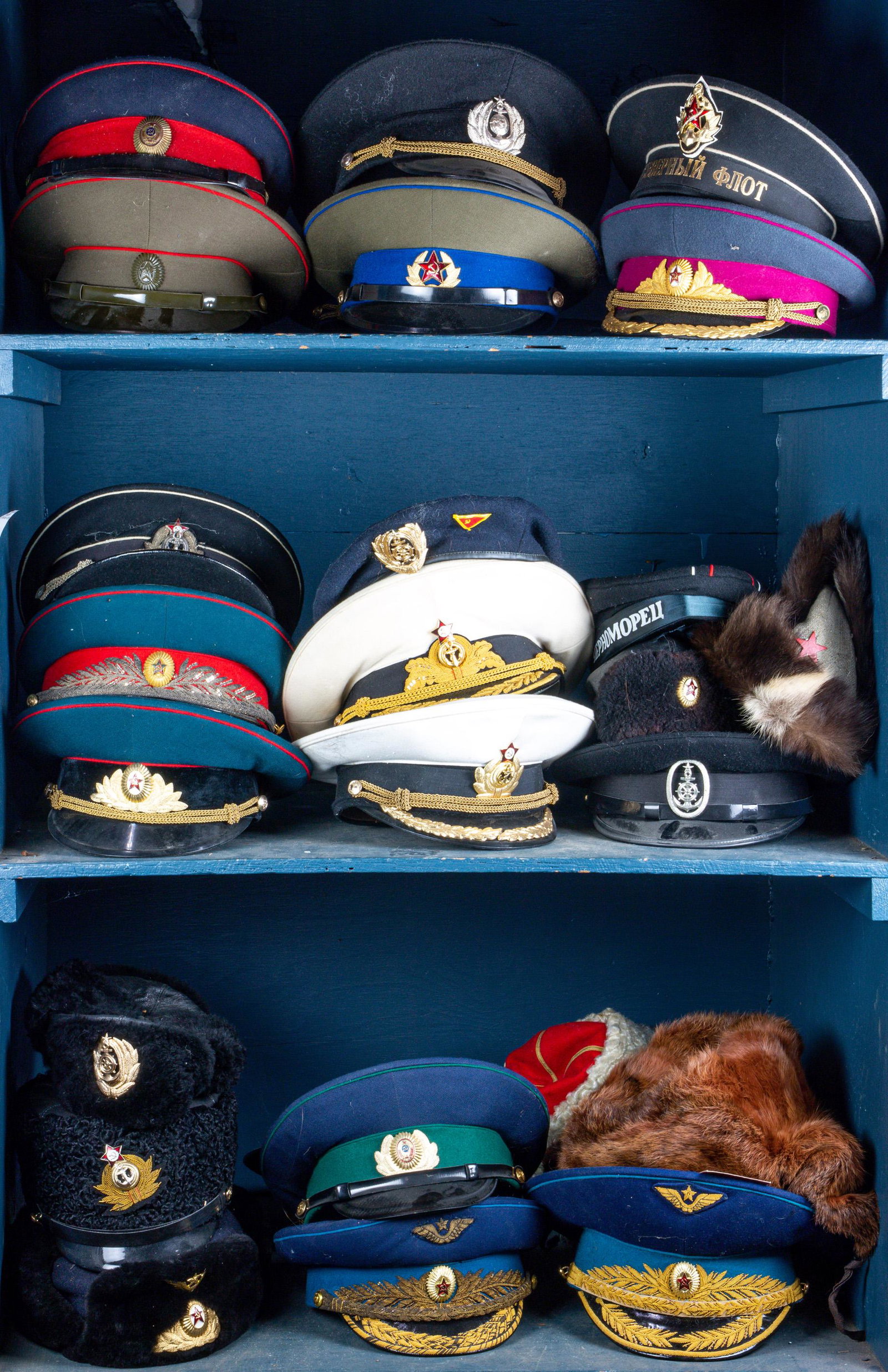 Three shelves of USSR military hats, including KGB, (1 of 1)