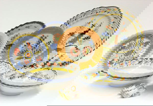 Quimper Henriot earthenware pottery: (Lot of 8) Quimper Henriot pottery, decorated with Breton male and female figures, in the Campagne and Parisian style, includes a charger, three soup bowls, two serving bowls with scalloped edges, a m