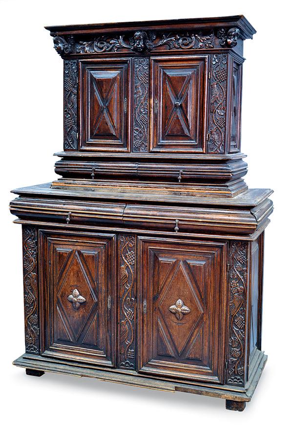 French Buffet a Deux Corps: French oak Buffet a Deux Corps, Brittany circa 1780, having a crest with figural carved putti medallions centered with floral sprays, above the carved and panelled cases having relief carved leaf and 