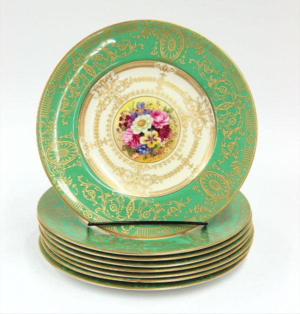Royal worcester service plates: (lot of 8) Royal Worcester porcelain service plates, having a green border with gilt scrolling accents around the floral decorated medallion, signed E. Phillips, marked Royal Worcester, Made in Englan