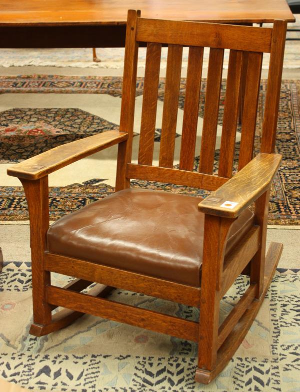 L & J.G Stickley arm rocker: L & J.G Stickley arm rocker, having six vertical back slats, chair retains its original spring drop in seat, and is signed with ''The work of'' label under arm, 36''h x 27''w