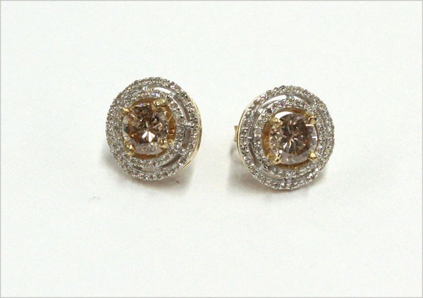 Yellow gold diamond earrings: Diamond earrings; mounted in 14k yellow gold, center set with (2) round champagne colored diamonds weighing 1.73 cts, accented around with single cut diamonds. Total weight of earrings 3.3 grams