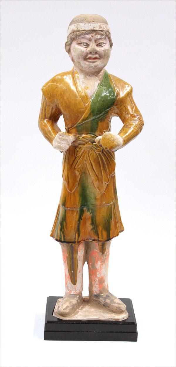 Chinese Tang Style Sansai Glazed Groom Figure: Chinese large Tang-style partially sansai glazed figure of a groom, standing in a thick green-and-yellow splashed tunic over red pigment-painted leggings and black boots, his hand to the front as if h