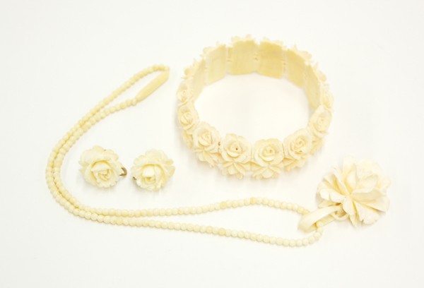 Carved Ivory Jewelry: (lot of 3) Group of carved ivory jewelry, consisting of a bead necklace chained with a rosette pendent; together with a pair of similarly carved; along with a bracelet composed of small rosette panels