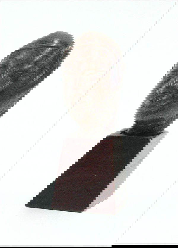 Burmese Bronze Figural Fragment, 18th/19th: Burmese patinated bronze fragment, 18th/19th century, cast as the head of a devotee with a close fitting cap framing the face with large eyes and full lips (losses), 2''h; Provenance: The Carmen M. an