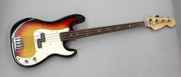 Dave Lario electric Bass guitar: Electric bass guitar, custom made by David Lario for his personal use, having a sunburst body with a white pickguard, with a Badass fretless bridge
