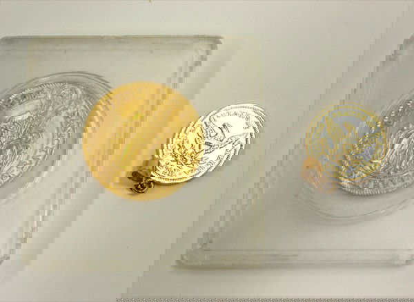 Two gold coins: (lot) of two gold coins, including; an 1853 2 1/2 dollar US Liberty head coin with soldered bail for pendant suspension. Total weight of Liberty coin 4.5 grams and a gold coin stamped 1598. Total weig