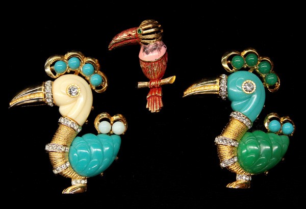 Hattie Carnegie fashion jewlery pins: (lot of 3) Hattie Carnegie fashion jewelry pins, including two gold tone ''Dodo Bird'' pins accented overall with turquoise, jade and ivory colored carved decoration and clear rhinestone highlights, t