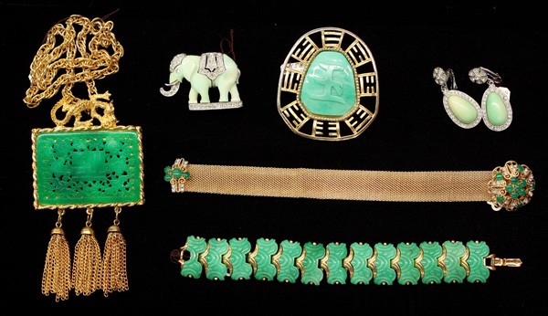Fashion jewelry inclding Hattie Carnegie: (lot of 6) Asian inspired pieces of fashion jewelry by Hattie Carnegie including; a gold tone brooch with jade colored carved stone inset, a jade colored and clear rhinestone decorated elephant pin an