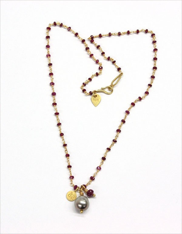 Yellow gold ruby bead Tahitian pearl necklace: Ruby bead and Tahitian pearl chain necklace; mounted in 18k yellwo gold, set with (64) ruby faceted beads and (1) baroque Tahitian cultured pearl. Total necklace weight 7.3 grams. Necklace length 16''