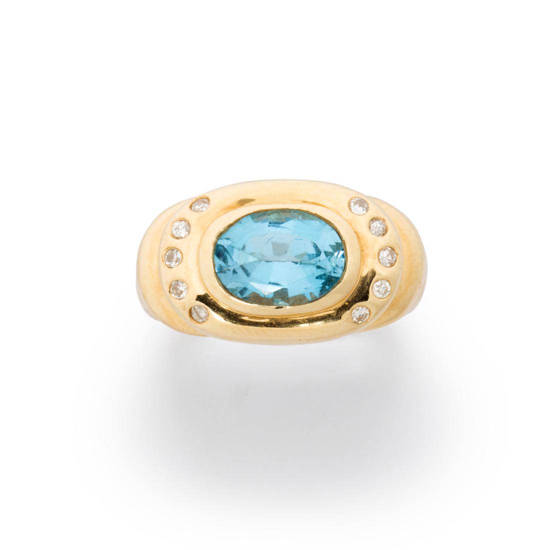 A blue topaz, diamond and fourteen karat gold ring (1 of 2)